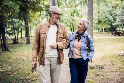 Active older adults walking outdoors to maintain strength and cardiovascular health.